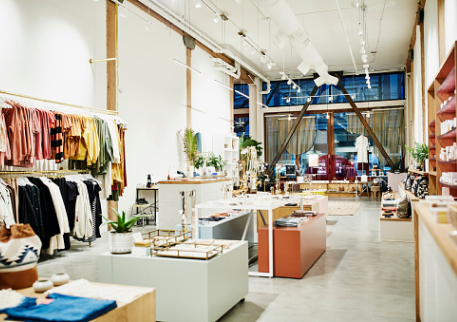 An large, airy storefront interior filled with colorful clothes